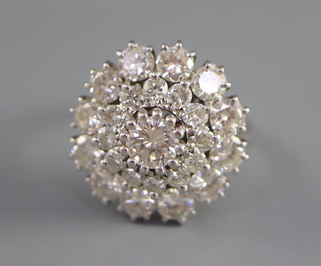 A modern 14ct white gold and diamond cluster ring,